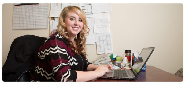 Social Work BSW student works at a laptop in an office